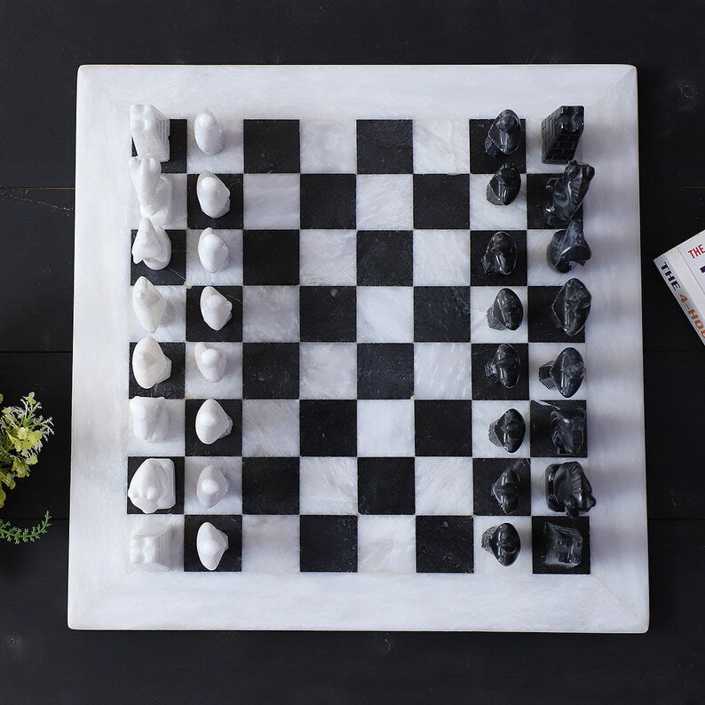 Marble chessboard with abstract black and white pieces