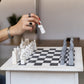 White and Black Matt Marble Statue Chess Set placing on the table and a women playing chess