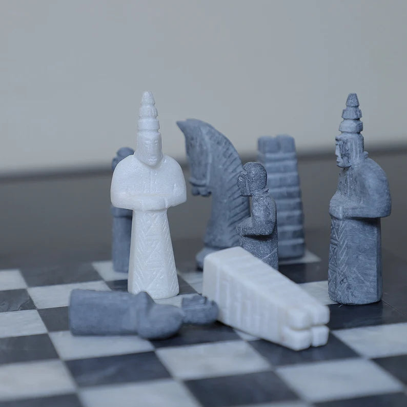 black and white egyptian gods chess set and characters placing on the table