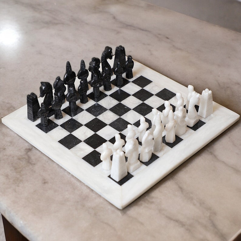 white and black chess board with egyptian gods chess pieces
